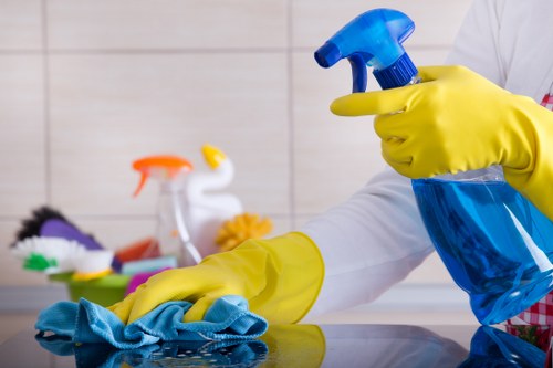Cleaner using safe carpet cleaning practices with protective equipment