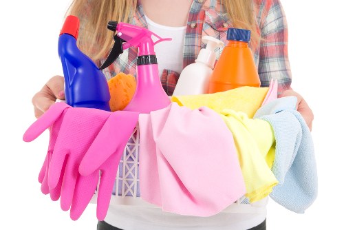 Trained carpet cleaner using protective gloves and equipment
